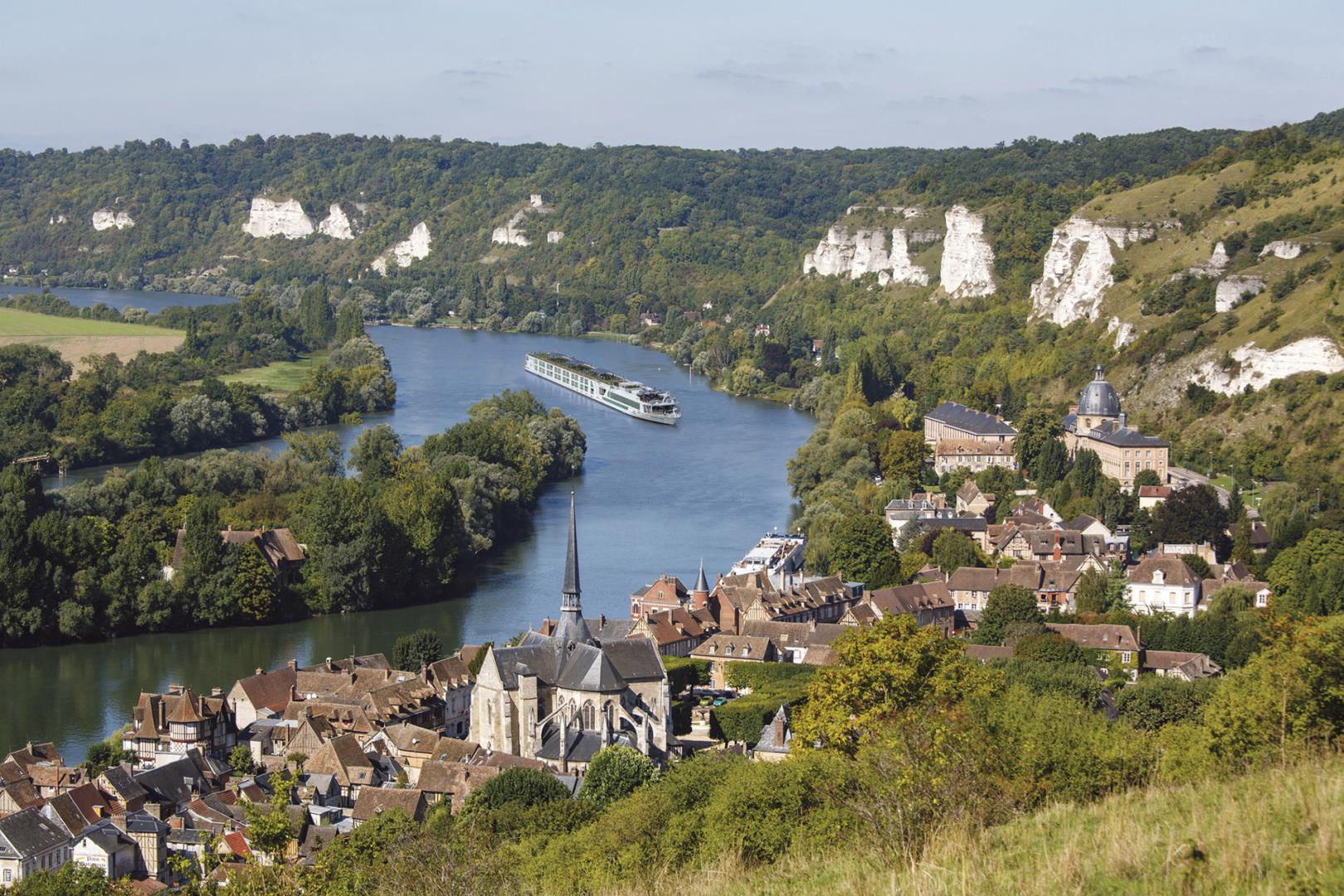 Exterior view of Scenic Gem sailing near Les Andelys castle